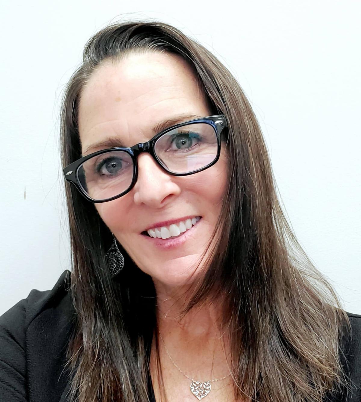 Headshot of Kim Klabe taken in front of a white background