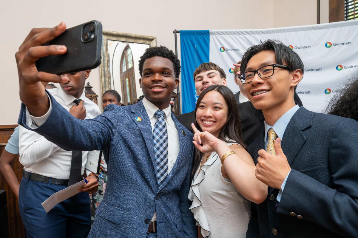 3 student graduates of the Gwinnett Youth Commission pose together for a selfie