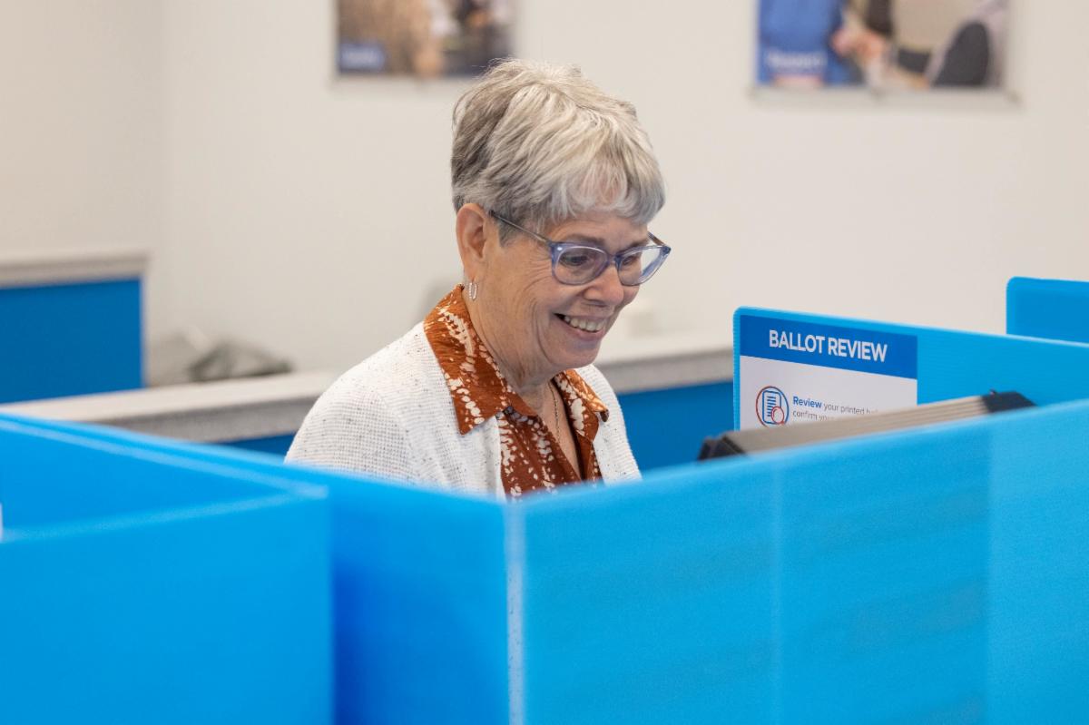 woman voting in election at precinct