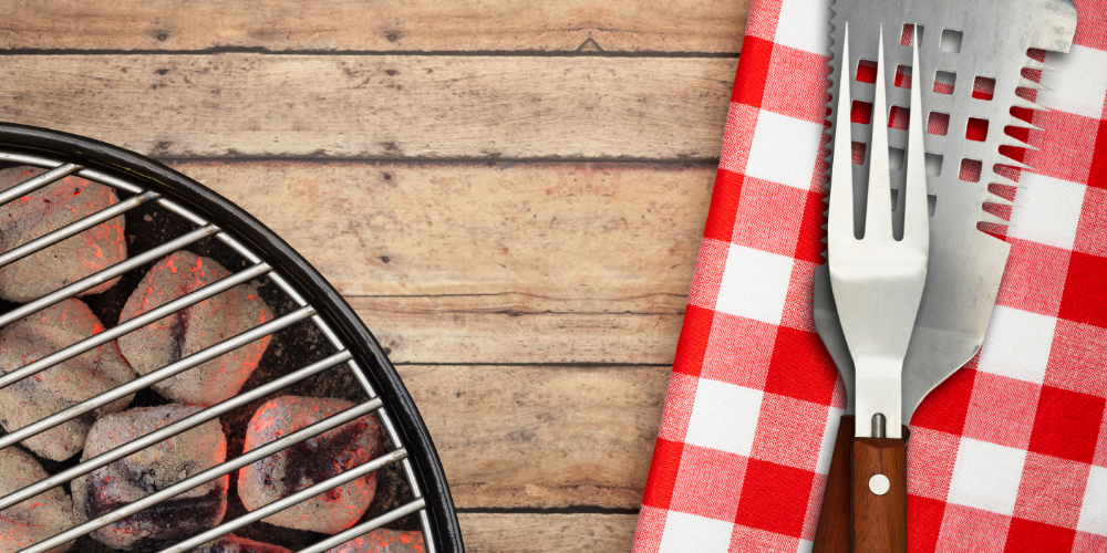 BBQ grill and tools on a gingham napkin