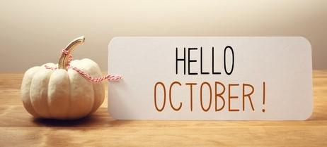 Image of a small white pumpkin with a card next to it stating Hello October
