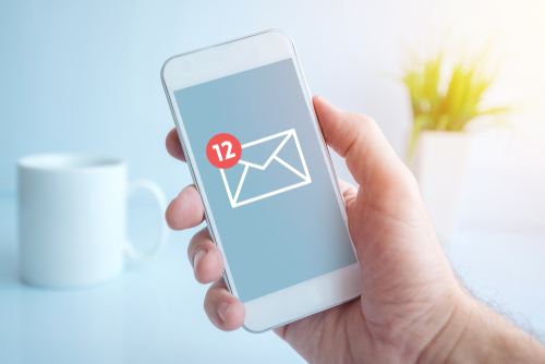 New text messages notification on smartphone screen in male hand_ selective focus