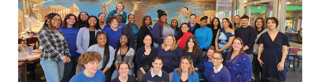 Fearless! staff grouped together, all wearing a shade of blue. 