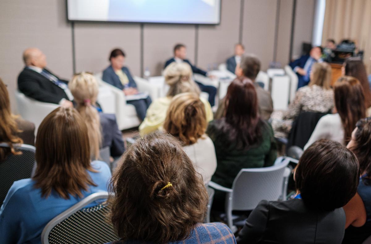 A pjoto of a group of parents speaking in front of a class