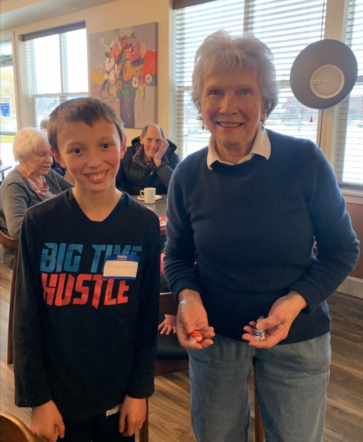 A Sibshop youth and a Williston Place resident adult smile after the youth showed the adult how to juggle