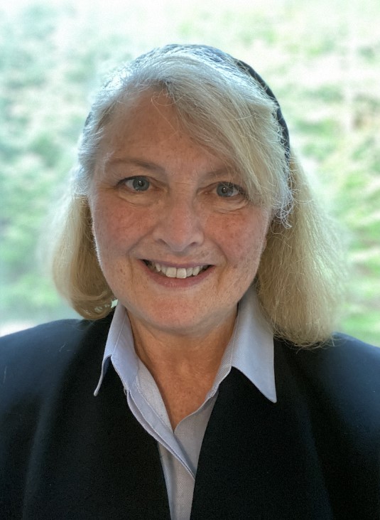 Photo of VFN Interin Executive Director, Michelle Kessler, wearing a white collared shirt and black cardigan.