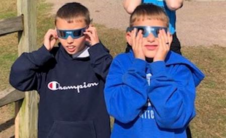 Two youth wearing eye protecting glasses
