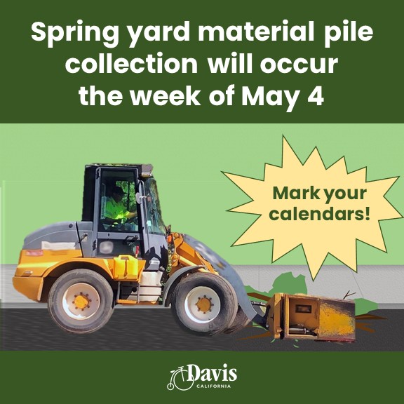 green background with yard material being picked up by equipment