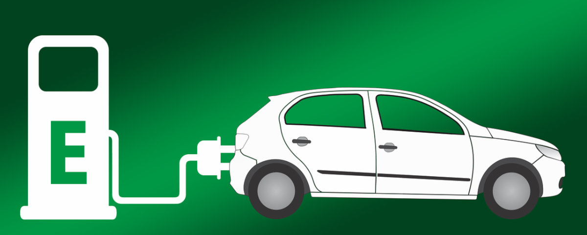 electric car plugged into an electric vehicle charger with a green background