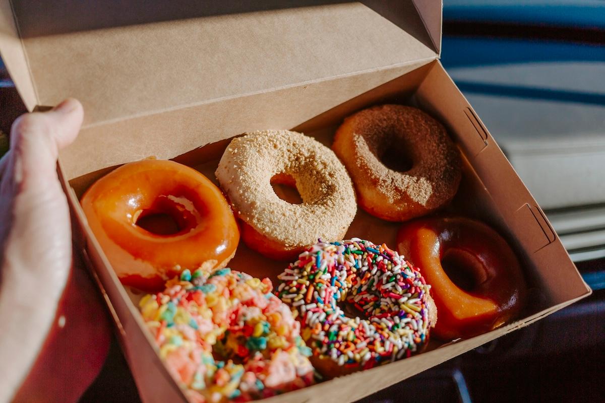 a box with six colorful donuts