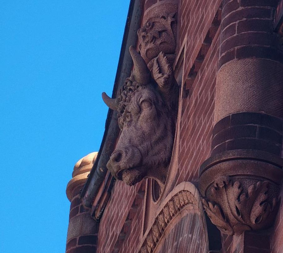 Color image of exterior of a brick building with ornamental designs