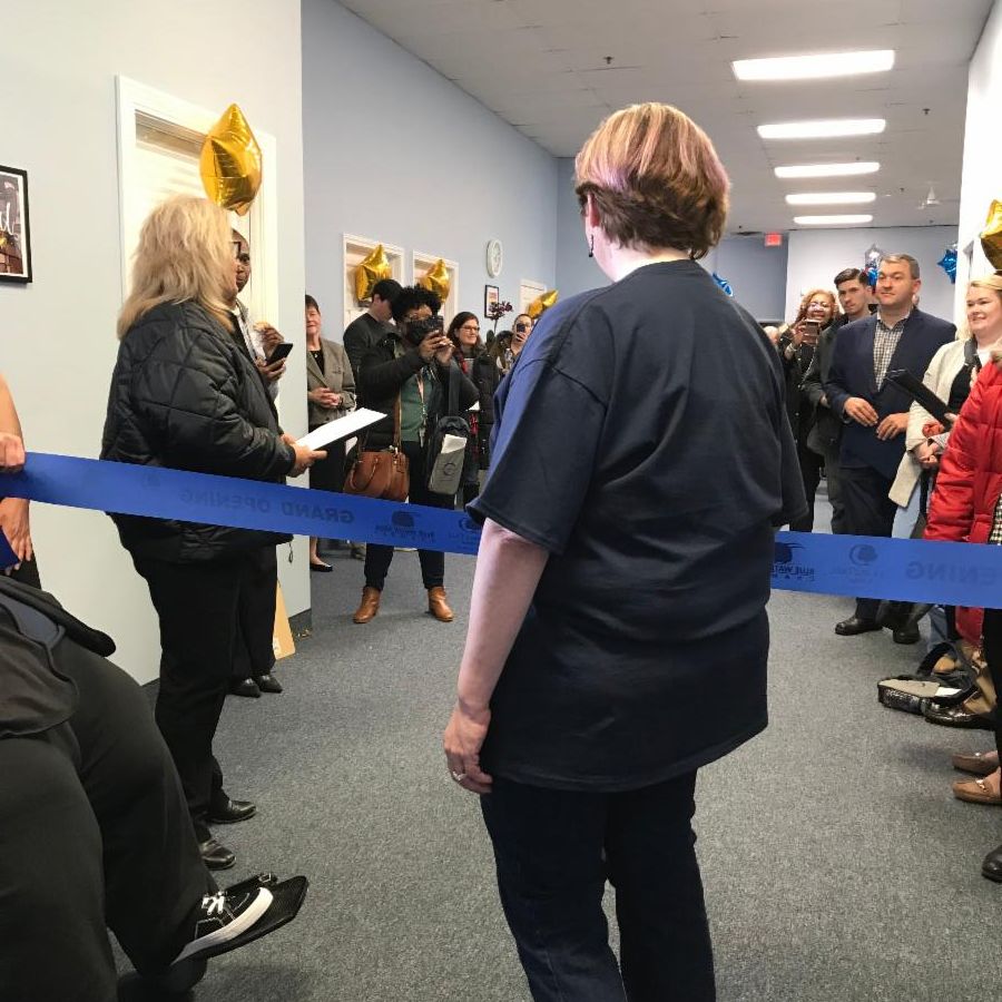 Staff and guests are preparing for the ribbon cutting ceremony at the DNEM Fort Gratiot office.