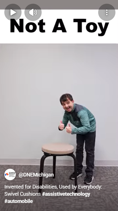 Screenshot from a Disability Network Eastern Michigan YouTube video about swivel seats. An enthusiastic man leans over a swivel seat with 2 thumbs up. The video caption says, Not a Toy.