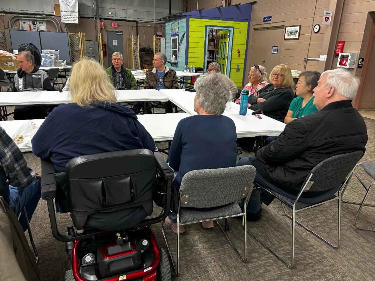 People seated around a table for a stroke support group