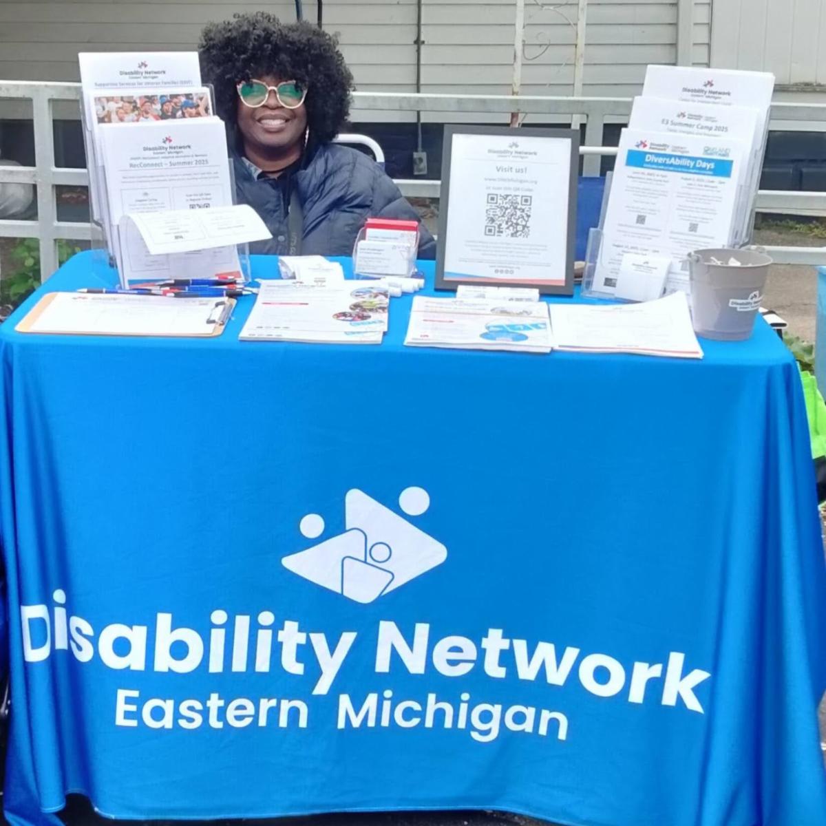 Supportive Services for Veteran Families staff is manning a Disability Network Eastern Michigan outreach table. Program flyers are on the table.
