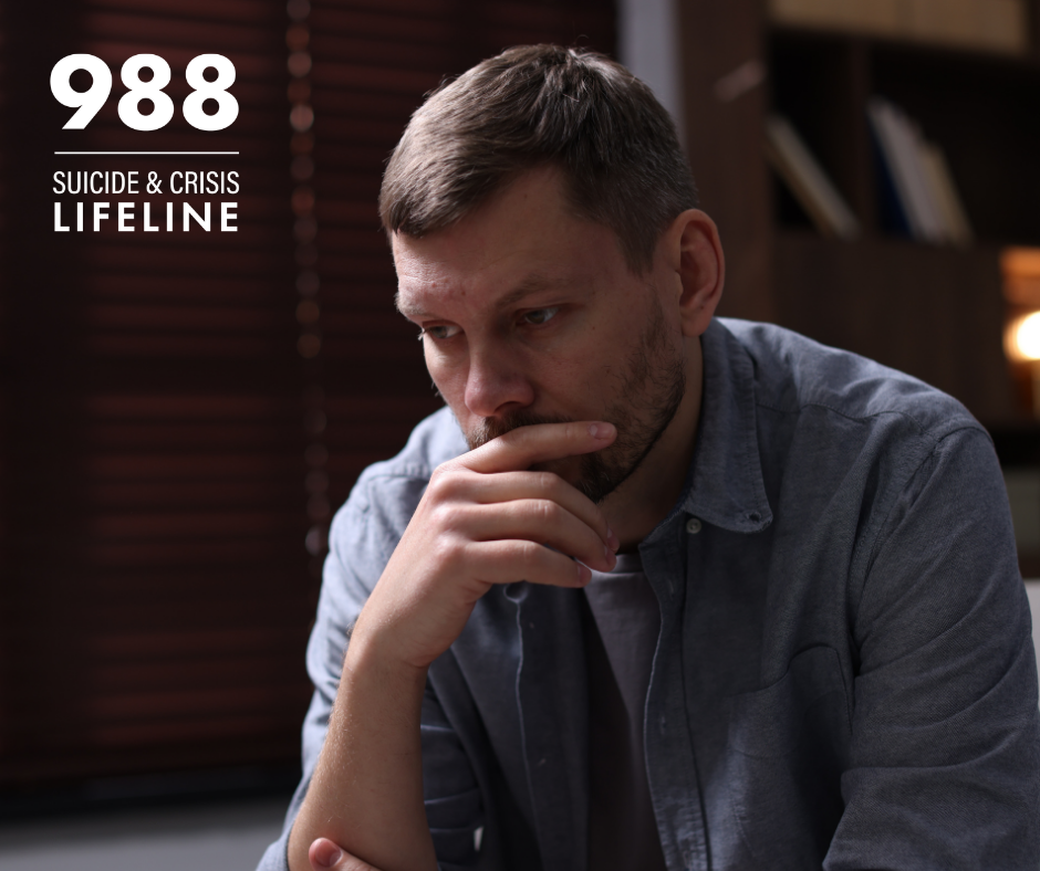 A depressed man at home. The 988 Suicide & Crisis Lifeline logo is in the corner.