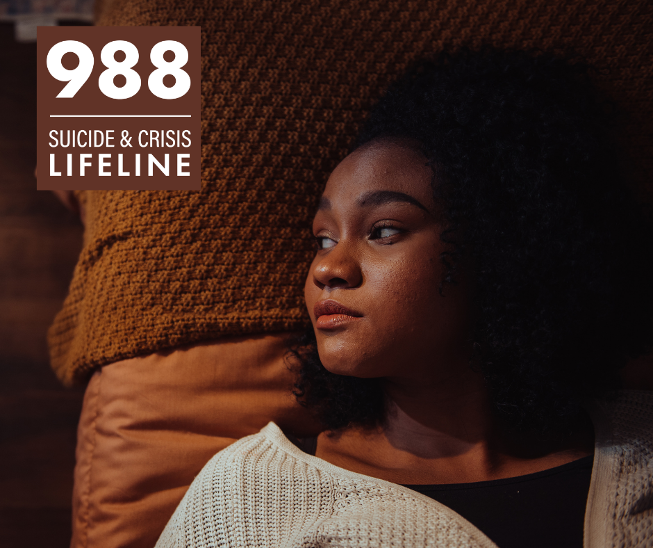 A young woman lying on a bed is staring into the distance. In the corner is the 988 Suicide & Crisis Lifeline logo.