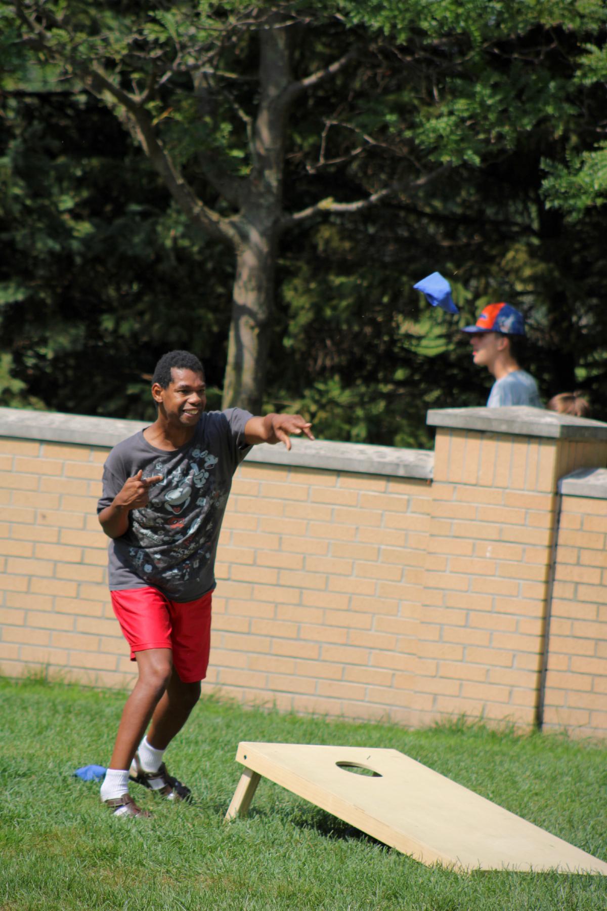 Young man playing corn hole.