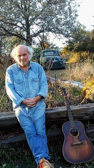 Jerry Ostensoe outside with guitar