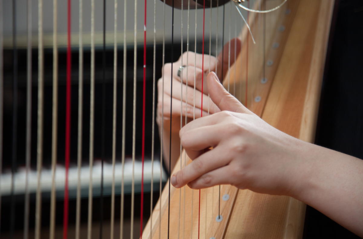 Stock photo of hands playing a harp