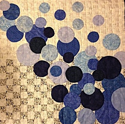 Blue, black and white applique design with many circles