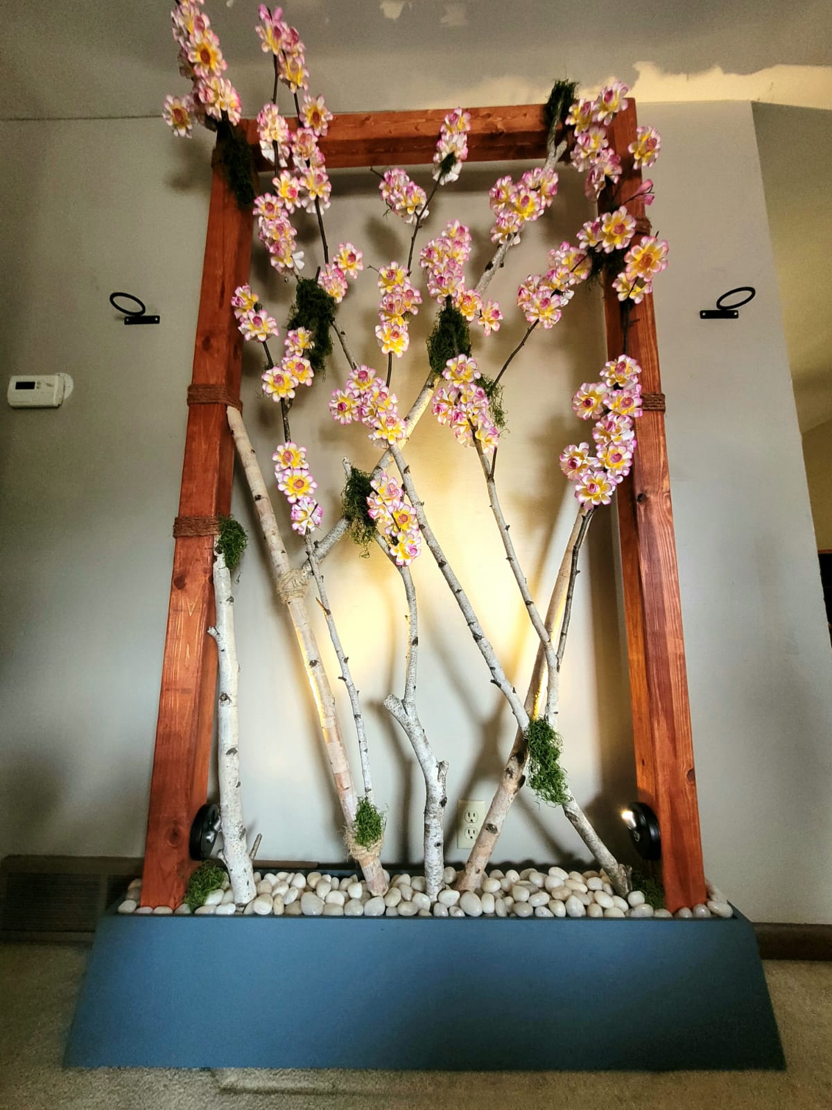Large wood frame with wood branches and handmade paper flowers