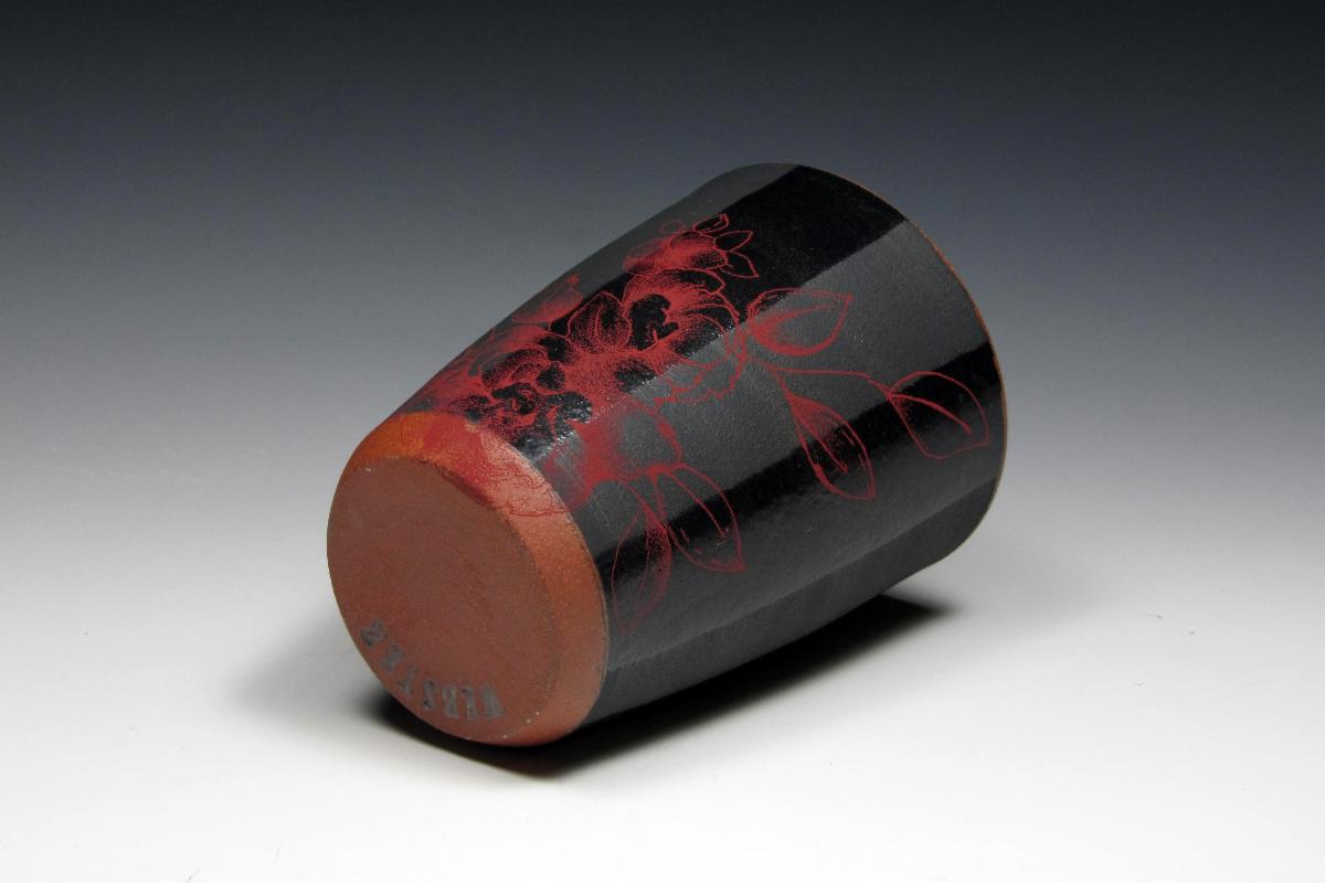 Black ceramic mug with red flower