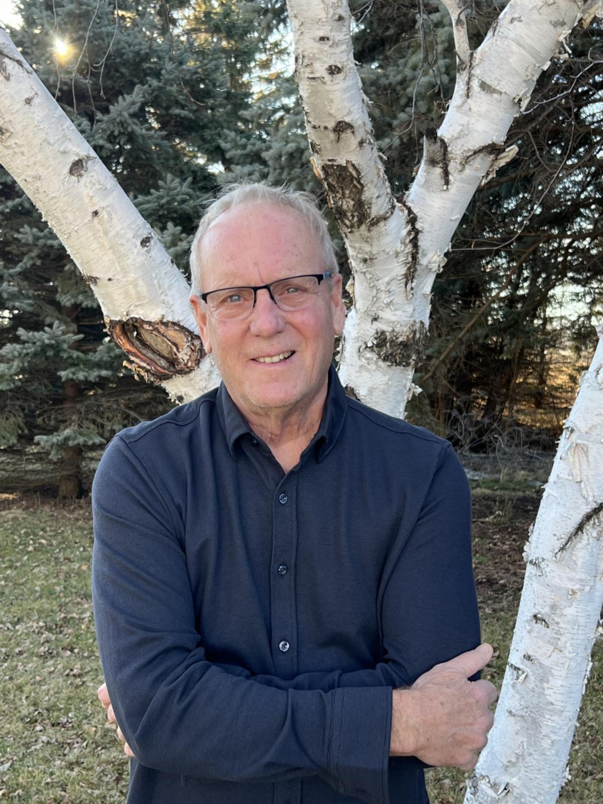 Headshot of Tom Listul outside in front of a tree