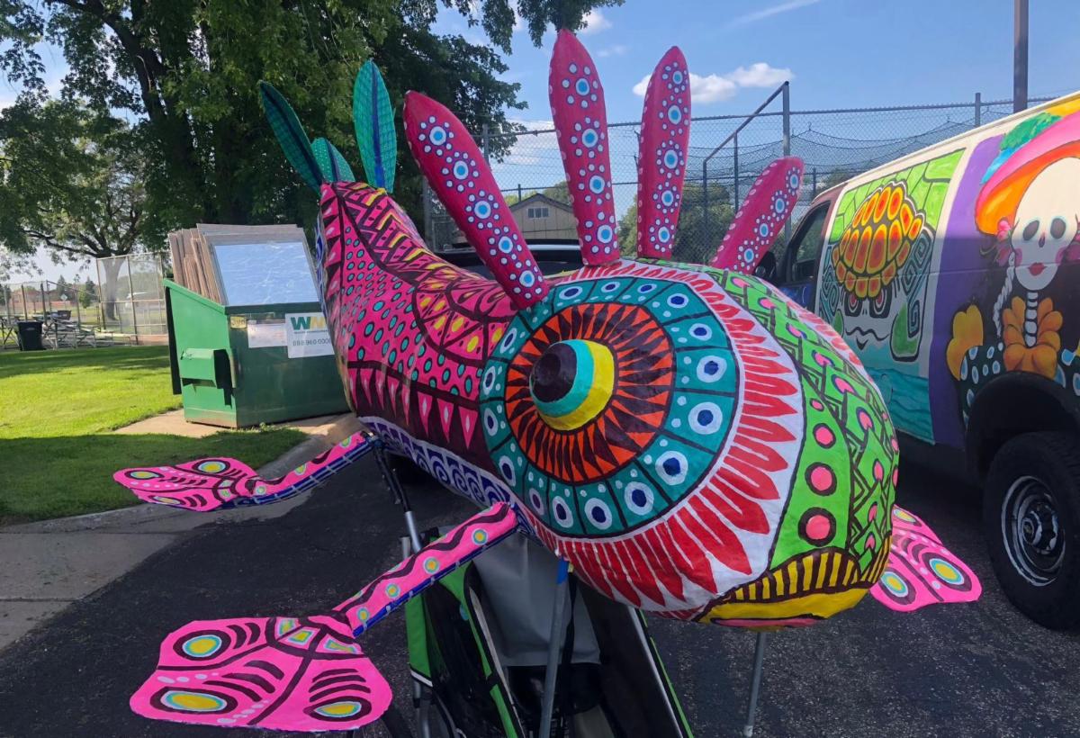Colorful fish sculpture with abstract designs painted on