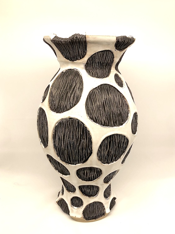 White ceramic vase with black spots with texture