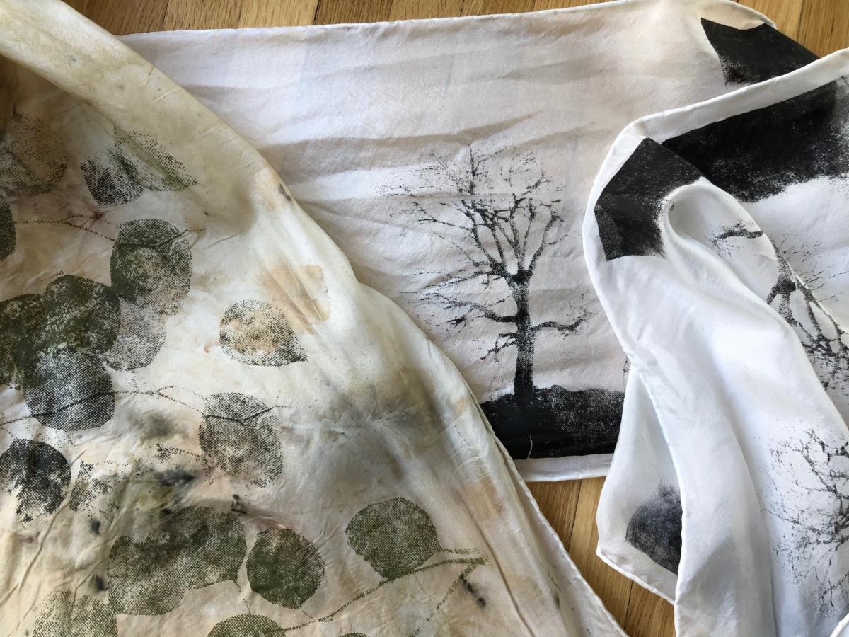 Artworks from Kerry Kolke-Bonk from printmaking workshop she took through a SMAC grant. White scarf with black print trees and leaf impressions.