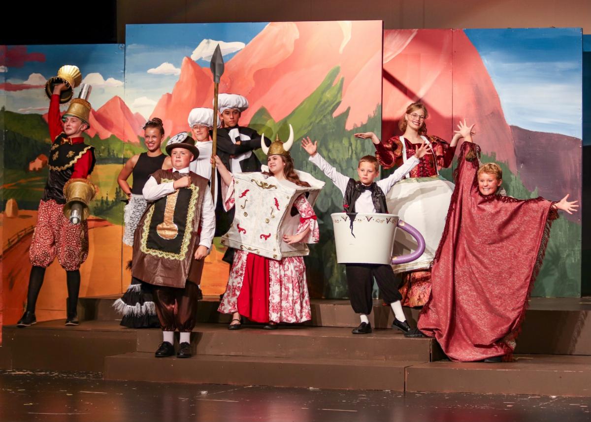 Youth dressed up as kitchen utensils for Beauty and the Beast production