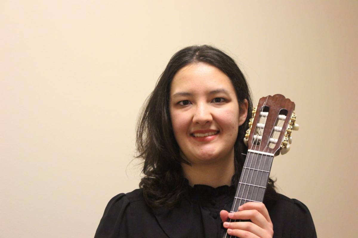 Headshot of artist with guitar