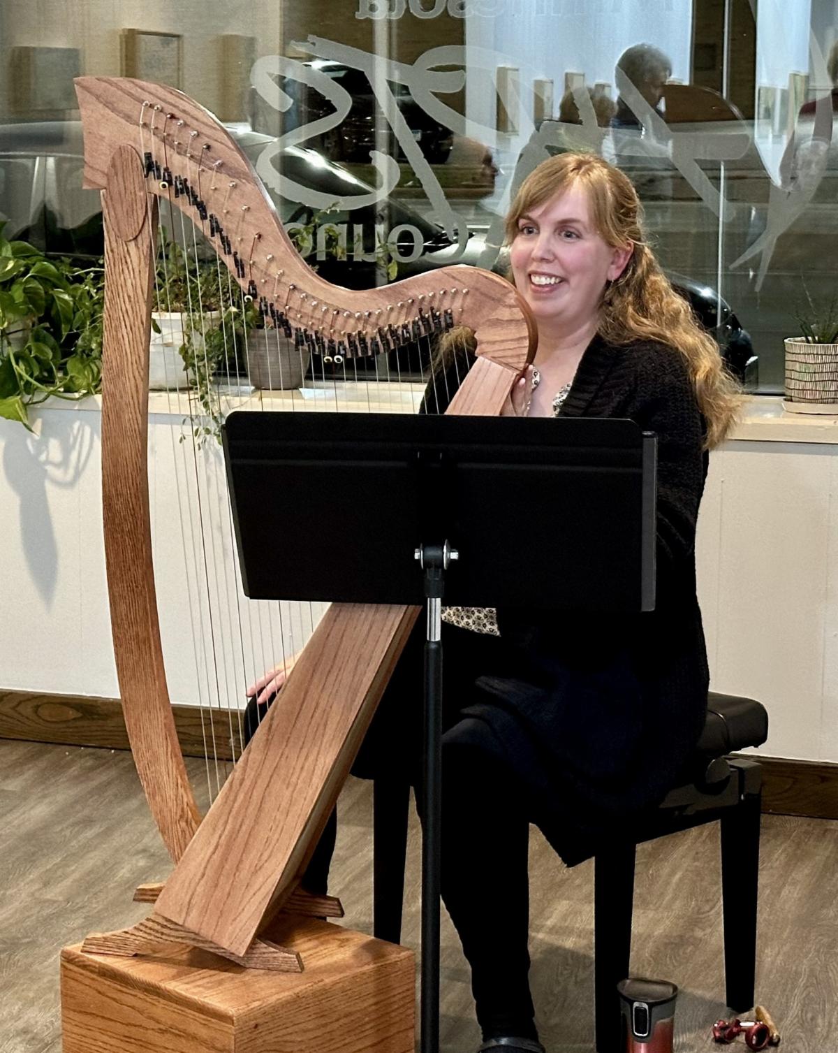 Woman playing large harp