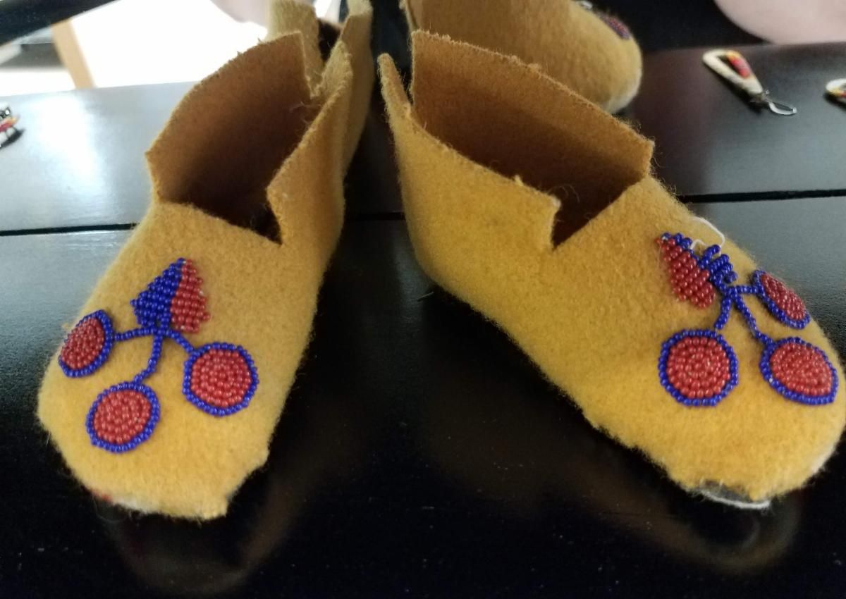 Shoes for infant with beadwork.