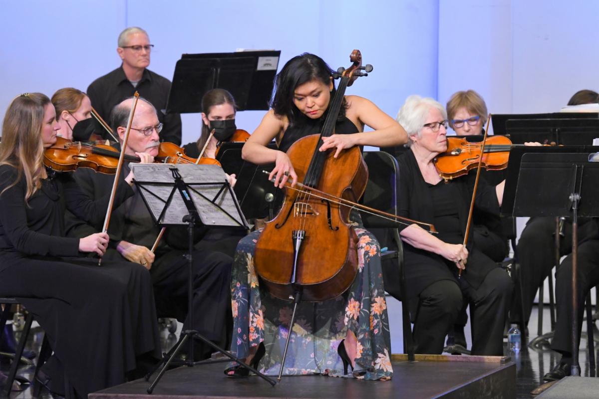 Orchestra concert with focus on a woman cellist