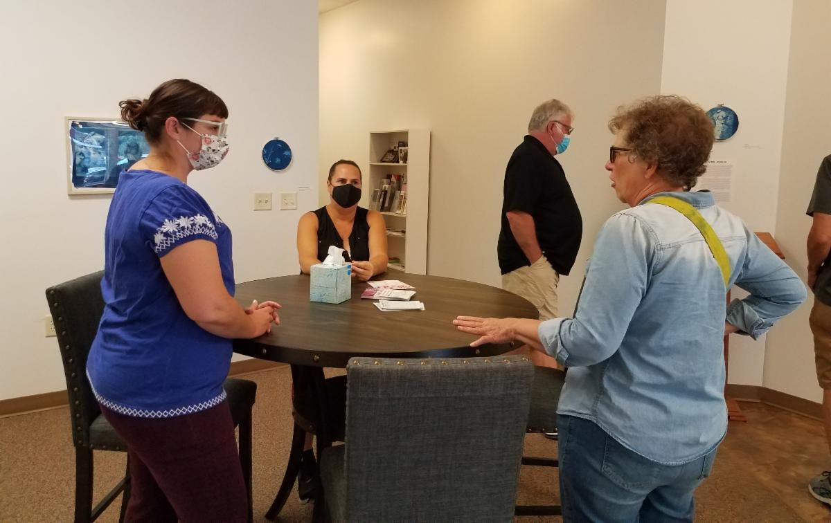 Anne talking with guests at the Artist Reception