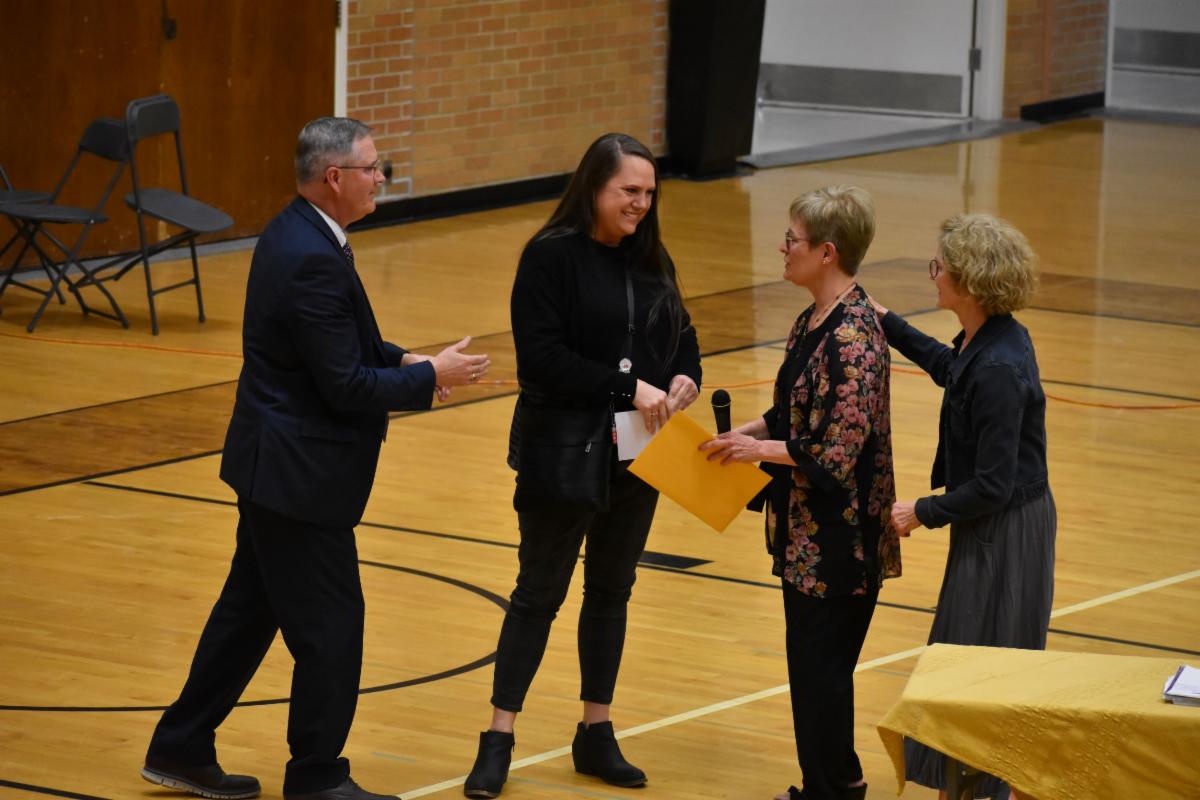 Nicole presenting Melanie with Prairie Disciple check
