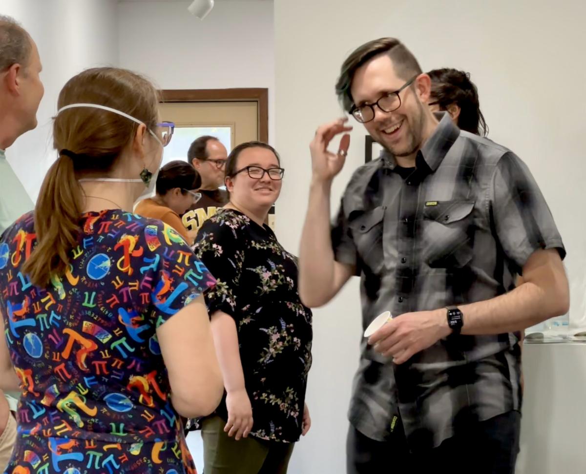 People talking and smiling at an Artist Reception
