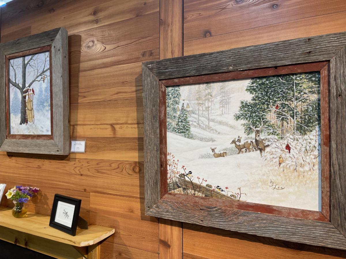 Wildlife painting of deer hanging on a wood wall
