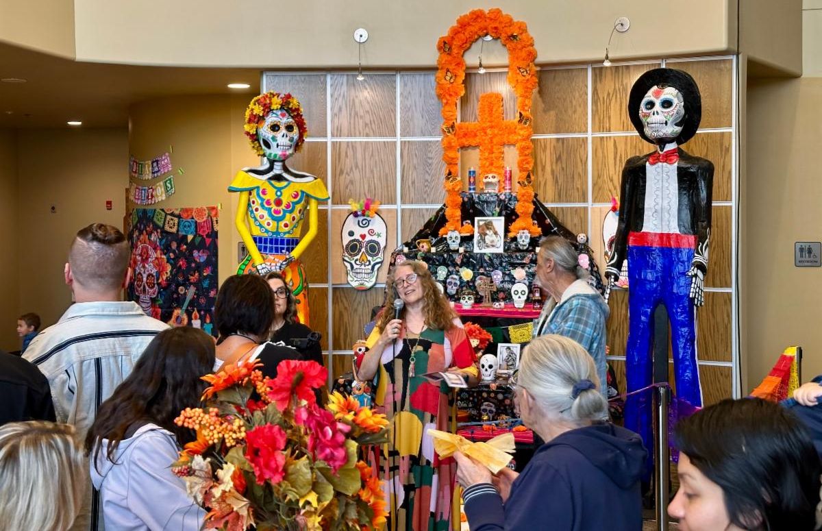 Memorial Auditorium Director Tammy Makram speaks with artist Gustavo about the catrina figures
