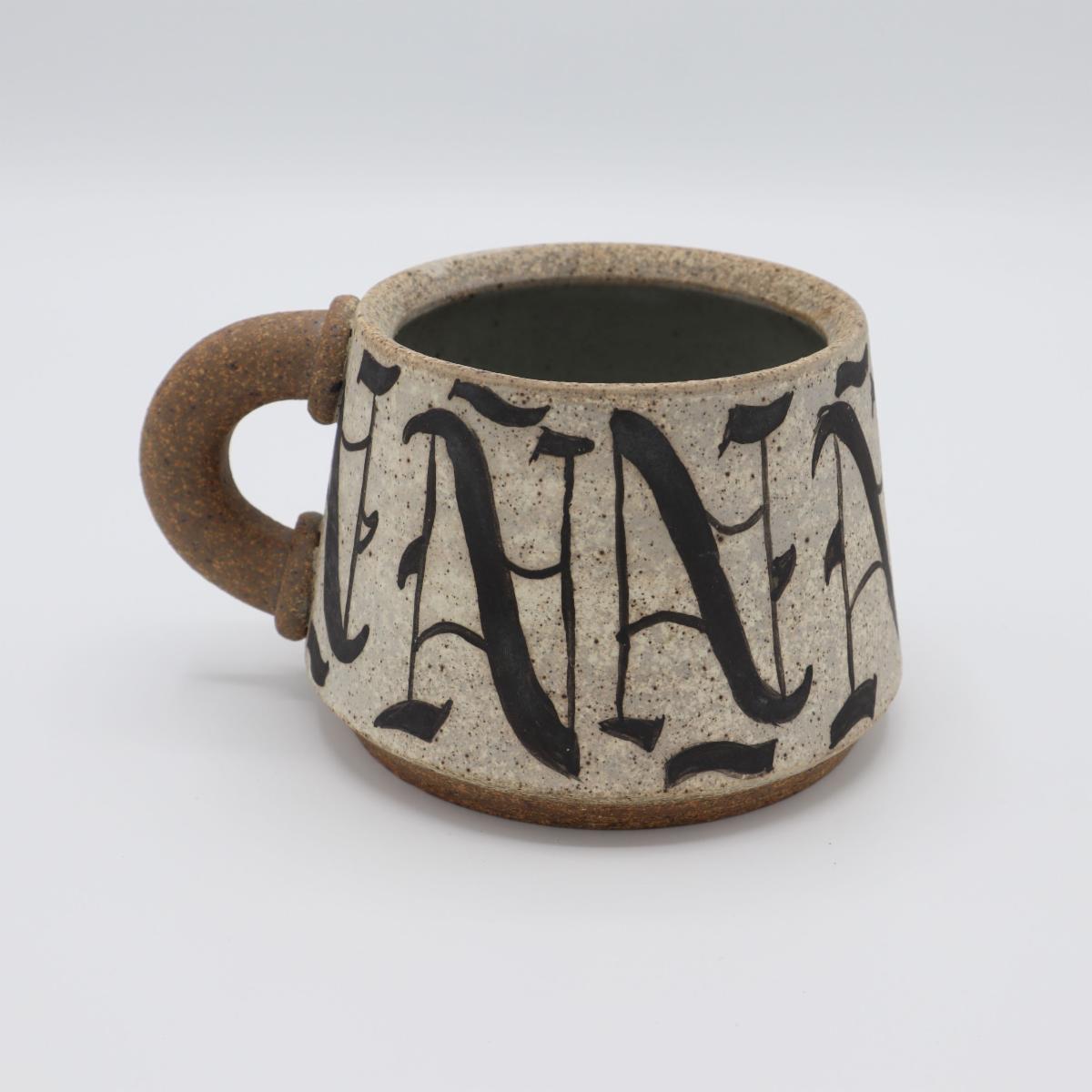 Cup with stylized letters on it