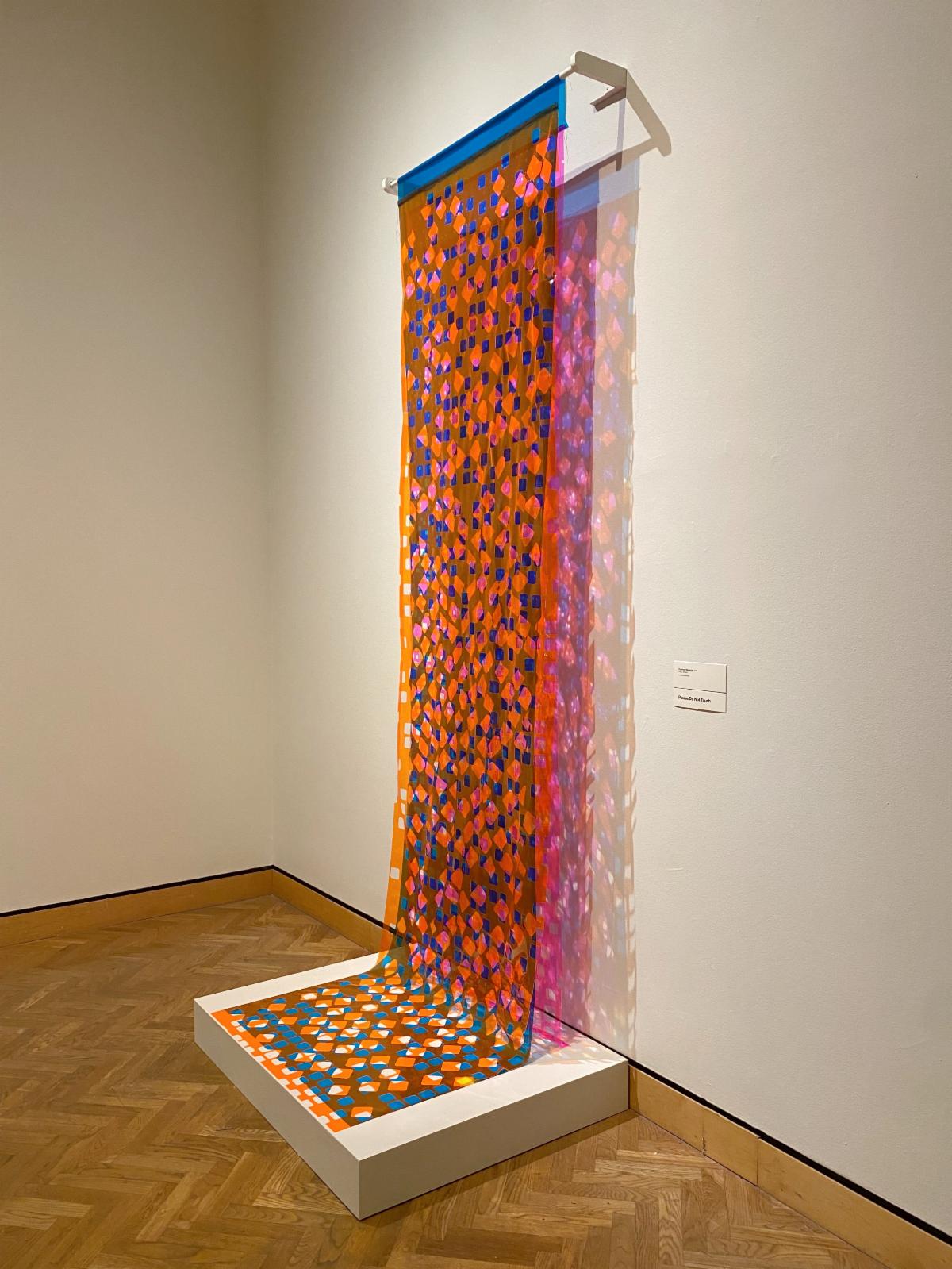 Equinox Weaving is informed by the light of autumn, blaze orange snow fences, and a reference to the traditions of quilting in rural America. Artist is exploring visual weaving, optical color mixing, and how light is projected. 