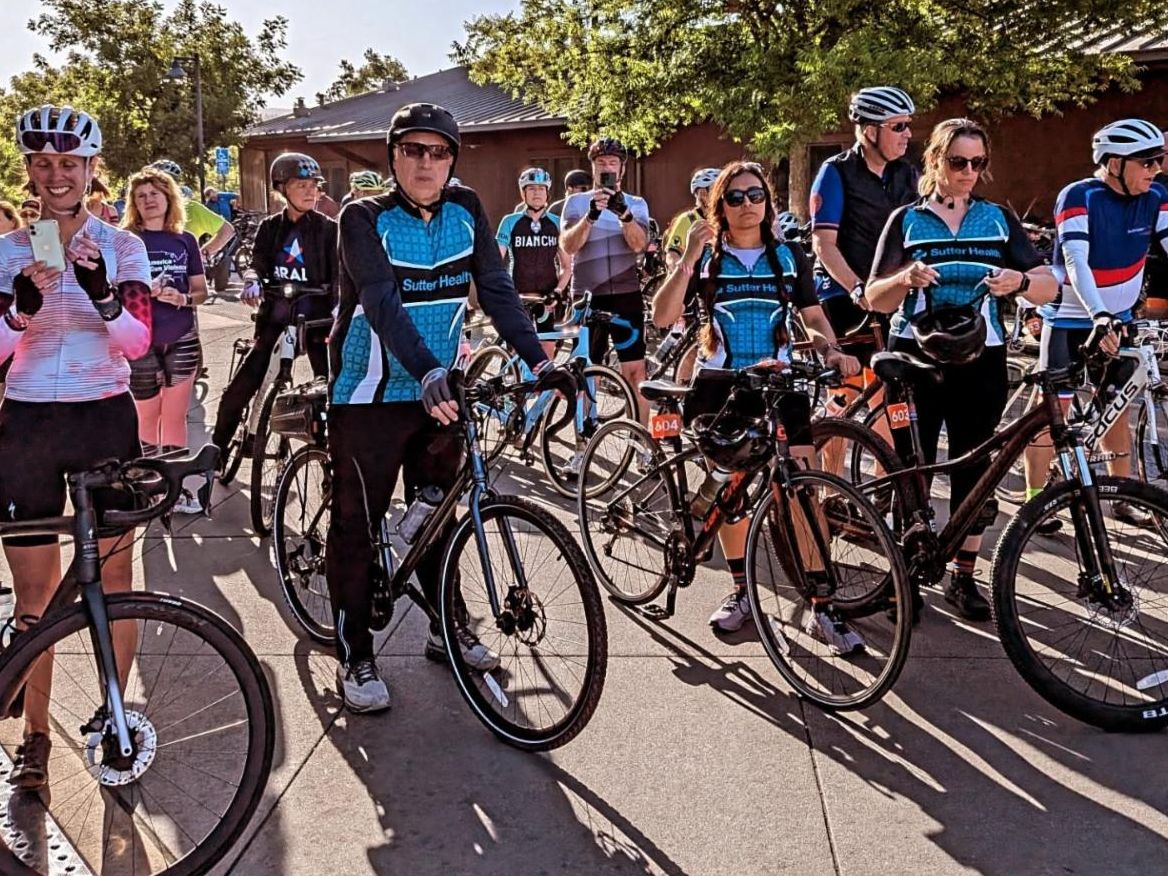 group of bicyclists dressed in bike gear waiting for the race to begin