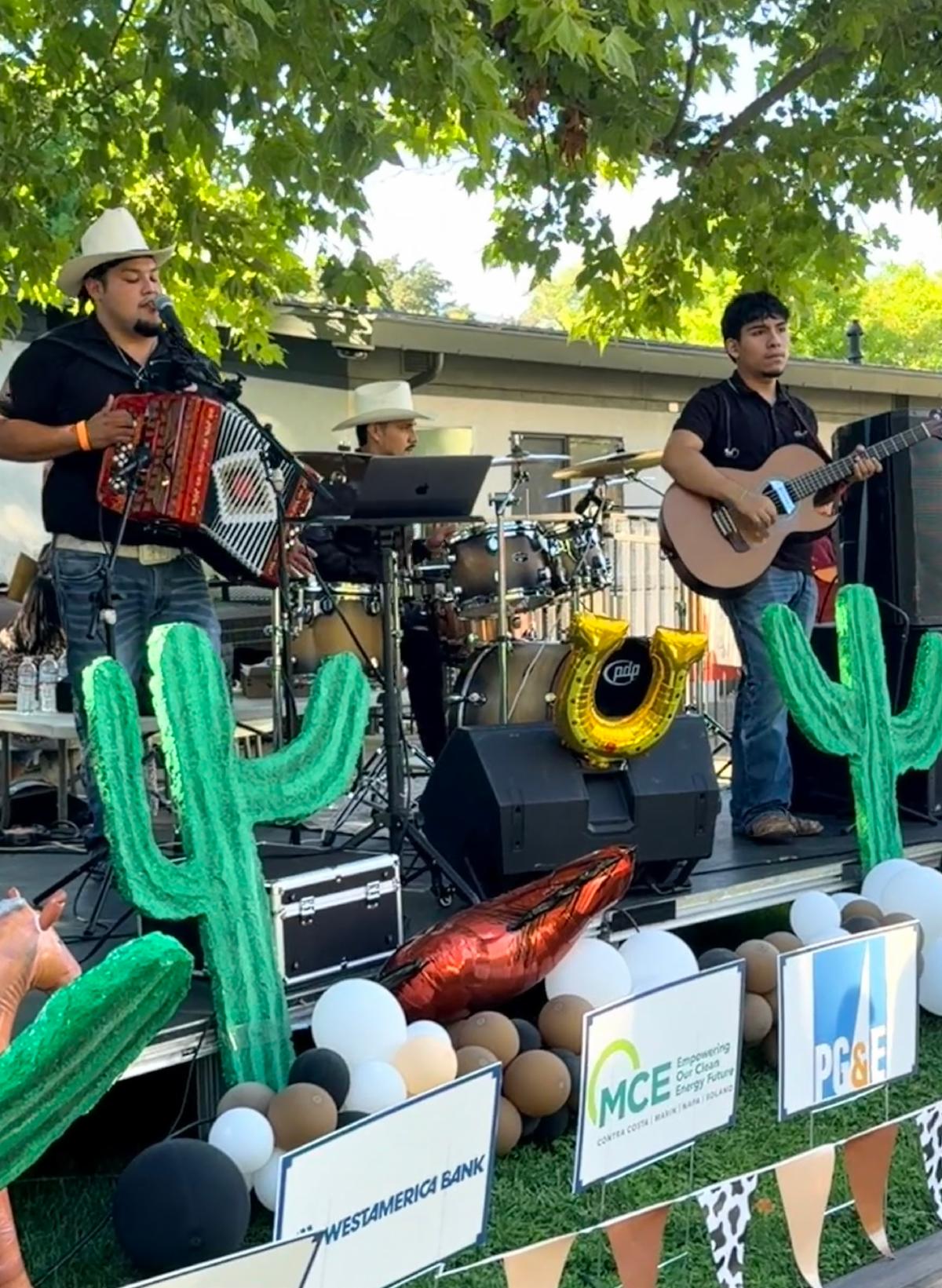Mexican band playing music on stage.