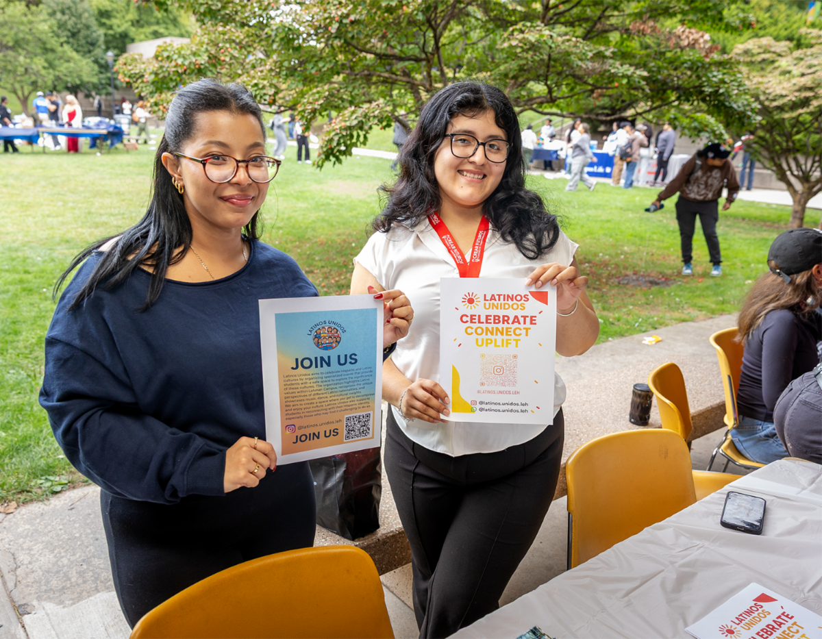 Two club members hold flyers