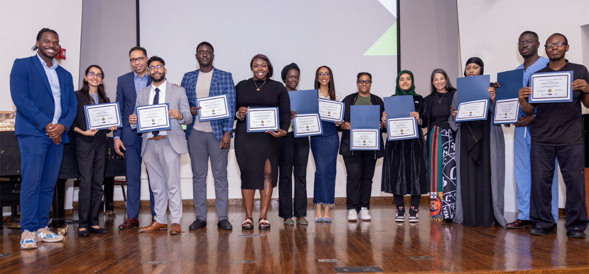 Group photo on stage with certificates
