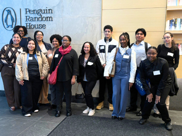 A group of students in front of the Penguin Random House sign