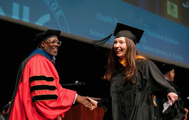 VP shakes a graduate's hand