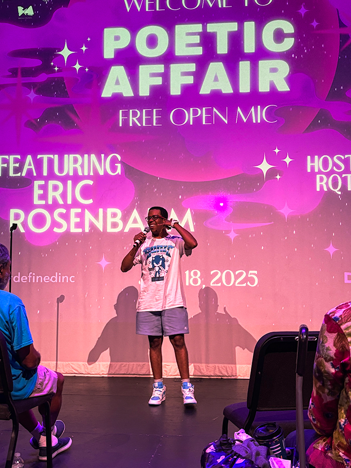 Magenta lighting and student with microphone in hand
